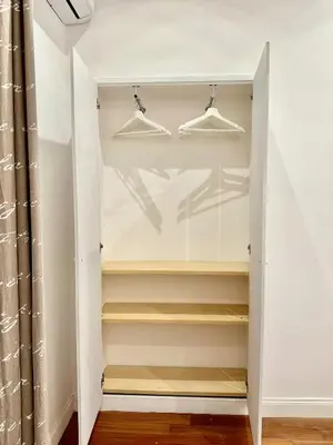 a walk in closet with hangers at Vacanze Romane Laterano in Rome