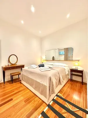 a bedroom with a bed and a table and a mirror at Vacanze Romane Laterano in Rome