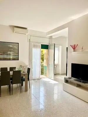 a living room with a dining table and a television at Appartamento Vacanze Romane in Rome