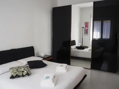 a bedroom with two beds and a mirror at Appartamento Vacanze Romane in Rome