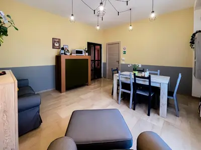 a living room with a table and a dining room at LE TRIPLETTE in Rome