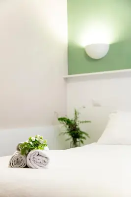 a pile of towels sitting on top of a bed at B&B Casetta Roma in Rome