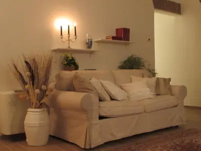 a white couch in a living room with candles at Casa Micheli in Centro ex Frattina Luxury Apartment in Rome