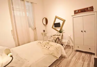 a bedroom with a bed and a mirror and a dresser at SottosopraSannio in Rome