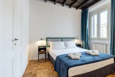 a bedroom with a bed with two towels on it at Rome As You Feel - Santa Margherita Design Apartment in Rome