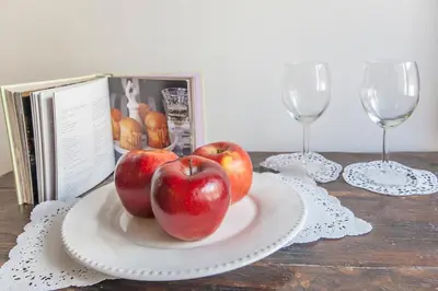 two apples on a plate on a table with wine glasses at ANTICA DIMORA FARNESE in Rome