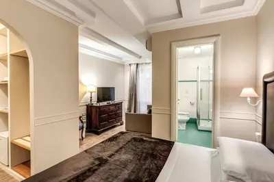 a bedroom with a king sized bed and a mirror at Aurelius Ponte Sant'Angelo in Rome