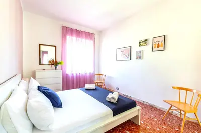 a bedroom with a bed and a window at Hostly - Family Home Stresa in Rome