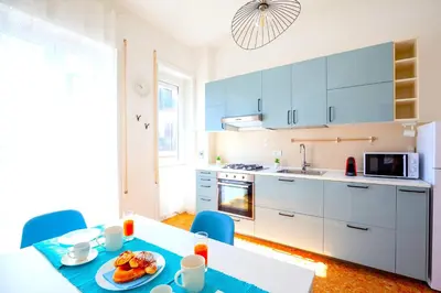 a kitchen with a table with a plate of food on it at Hostly - Family Home Stresa in Rome