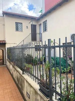 a fence in front of a house at Residenza niutta- roma in Rome