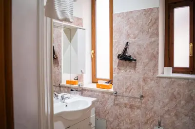 a bathroom with a sink and a mirror at A 200Metri Dal Vaticano, 2 Camere Da Letto in Rome