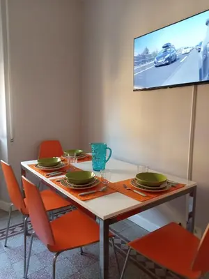 a dining room with a table with chairs and a tv at La CASA DI SABINA in Rome