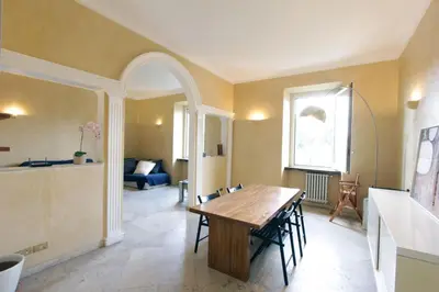 a living room with a wooden table and chairs at Cattaneo Flat in Rome