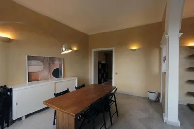 a dining room with a wooden table and chairs at Cattaneo Flat in Rome