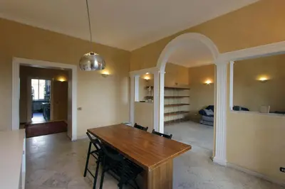 a dining room with a wooden table and chairs at Cattaneo Flat in Rome