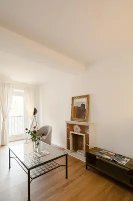 a living room with a table and a fireplace at Via Francesco Crispi Private Apartment in Rome