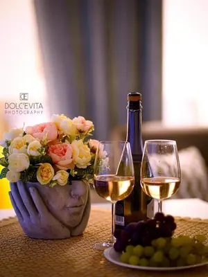a table with a bottle of wine and two glasses at Pandora apartments in Rome