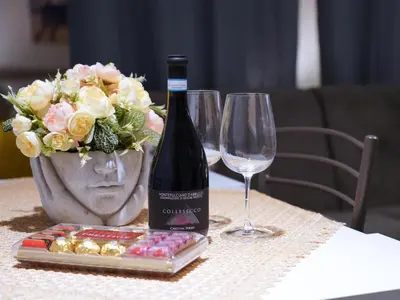 a bottle of wine and two glasses on a table at Pandora apartments in Rome