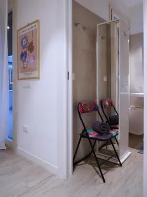 a room with two chairs and a mirror at Pandora apartments in Rome