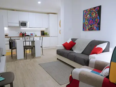 a living room with a couch and a kitchen at Pandora apartments in Rome