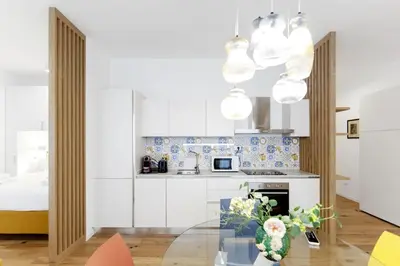 a kitchen with a glass table with a vase of flowers at Vatican Steps, Suite Mary, Strollingrome in Rome