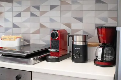 a counter with a coffee maker and a blender on it at Easy Apartment in Rome