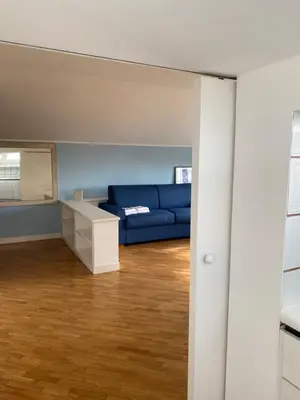 a living room with a blue couch and a table at Piccolomini Design Apartment in Rome