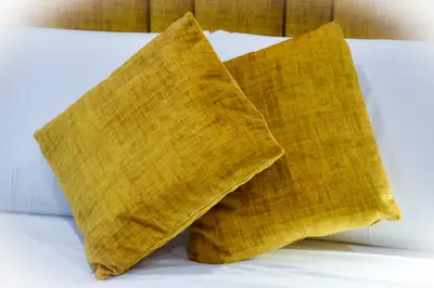 two brown pillows sitting on top of a bed at Alba Rosa Rooms in Rome