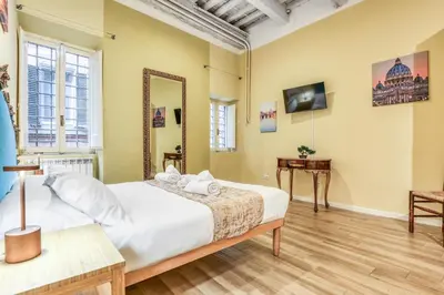 a bedroom with a large bed and a mirror at Easybnb - Domus Orbitelli in Rome