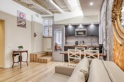a living room with a couch and a kitchen at Easybnb - Domus Orbitelli in Rome