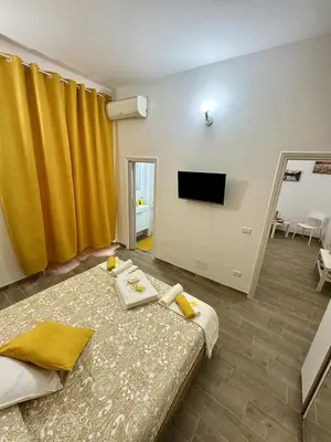 a bedroom with a bed and a lamp on a table at Paradise Suite Roma centro in Rome