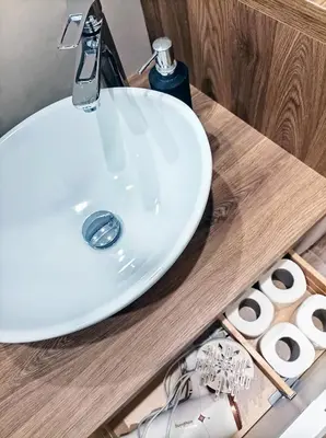 a white bathroom sink on a wooden counter with towels at Mamomi HOUSE in Rome