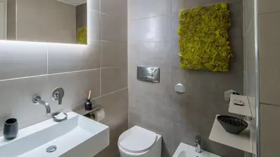 a bathroom with a white toilet and a sink at Ripetta Boutique Suites in Rome