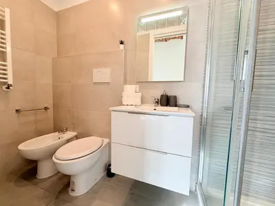 a bathroom with a toilet and a sink and a shower at Enjoy Vatican Holiday in Rome in Rome
