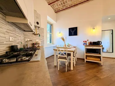 a kitchen with a table and a dining room at Enjoy Vatican Holiday in Rome in Rome
