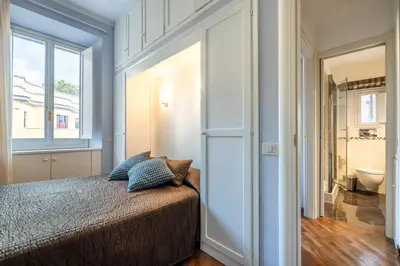 a bedroom with a bed and a bathroom at Piazza del Popolo Home 2 camere in Rome