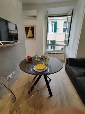 a living room with a table and a couch at Casa Aventino in Rome