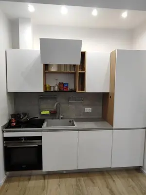 a kitchen with white cabinets and a sink at Casa Aventino in Rome