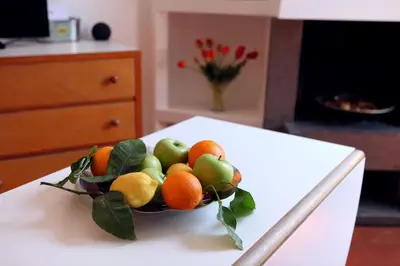 a bowl of fruit on top of a table at Scarpetta32 - Your home in Trastevere in Rome
