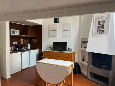 a living room with a table and a fireplace at Scarpetta32 - Your home in Trastevere in Rome