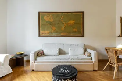 a living room with a couch and a map on the wall at Rome As You Feel - Two-Bedroom Apartment in Monti in Rome