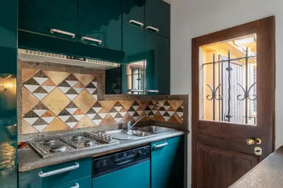 a kitchen with blue cabinets and a sink at GuestHost - Cozy Trevi Romance in Rome