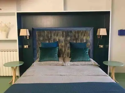 a bedroom with a large blue bed with two tables at Farnese Muse in Rome