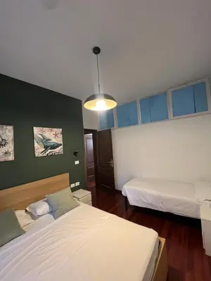 a bedroom with two beds and a light at Casa vacanza “Eden” in Rome