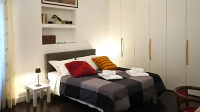 a bedroom with a bed with two towels on it at B&B Azuni Home in Rome