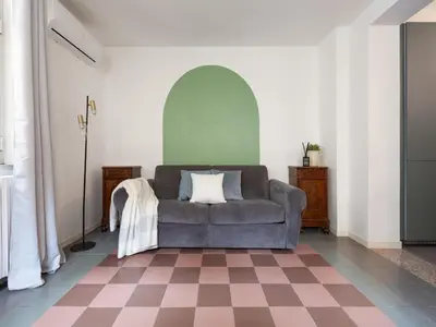 a living room with a couch and a checkered floor at The Best Rent - Large apartment a few steps from the Trevi Fountain in Rome