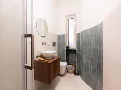 a bathroom with a sink and a toilet and a mirror at The Best Rent - Large apartment a few steps from the Trevi Fountain in Rome