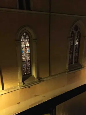 two stained glass windows on the side of a building at Domus romae esquilini in Rome