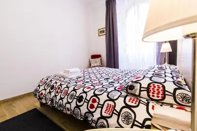 a bedroom with a bed with a black and white comforter at Colossehome - Dream House around the corner from Colosseum in Rome