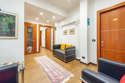 a living room with a couch and a door at ANDENIS TIBER HOUSE in Rome